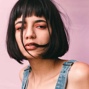 headshot of a person with front bang and bob hair styles